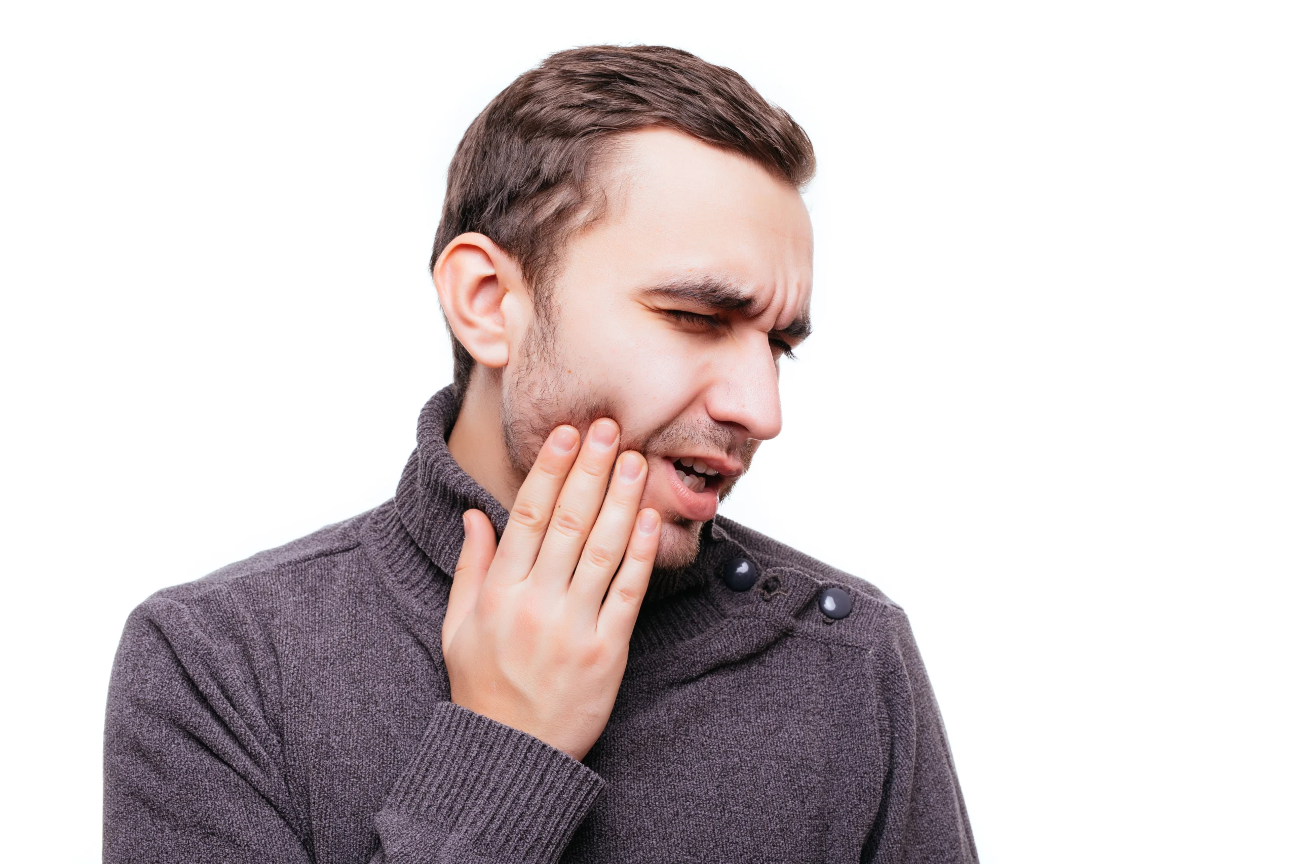 A handsome man suffering from jaw pain due to jaw implant complicaitons