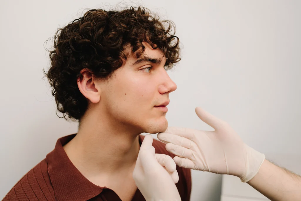 Man with custom cheekbone implants