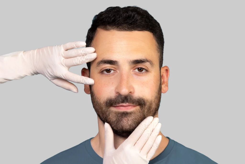 Plastic surgeon examining patient's face before deciding to do bioactive PEEK facial implants surgery